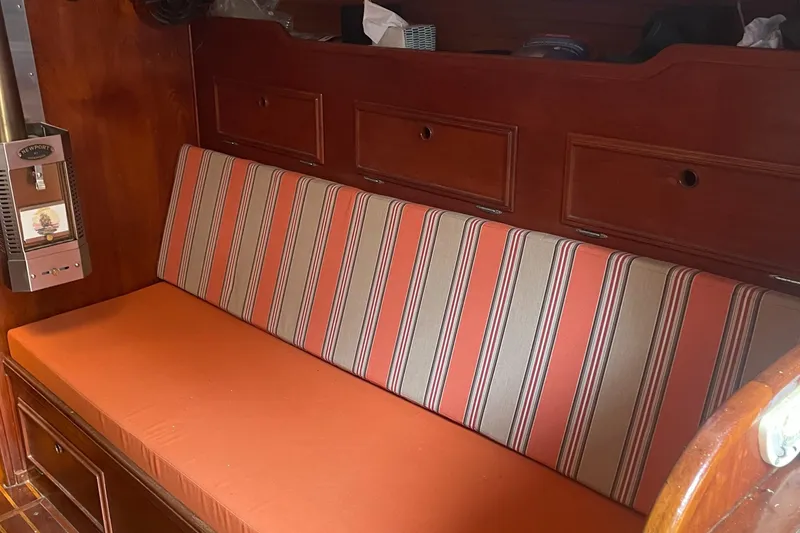 Slide: The Image of Interior of 1980 Cape Dory 36 sailboat with striped cushions and wooden cabinetry. - 24