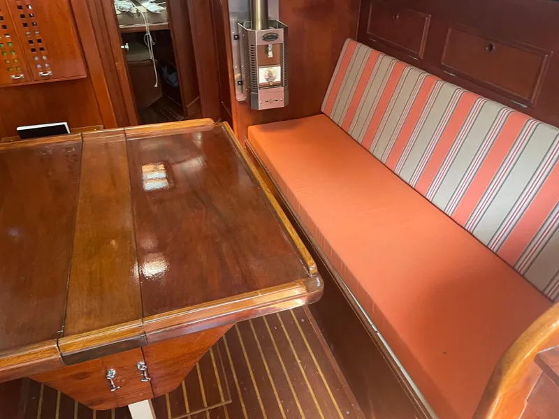 Slide: The Image of Interior of 1980 Cape Dory 36 sailboat with wooden table and striped seating. - 27