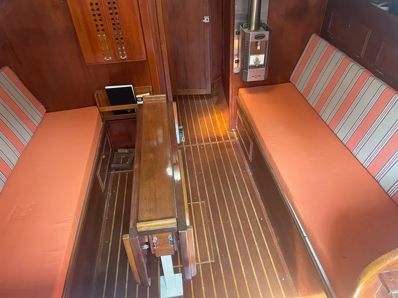 Slide: The Image of Interior of 1980 Cape Dory 36 sailboat with wooden furnishings and striped cushions. - 28
