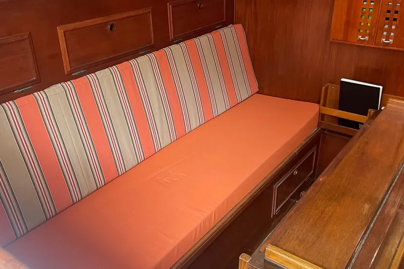 Slide: The Image of Interior of 1980 Cape Dory 36 sailboat with striped cushions and wooden cabinetry. - 30