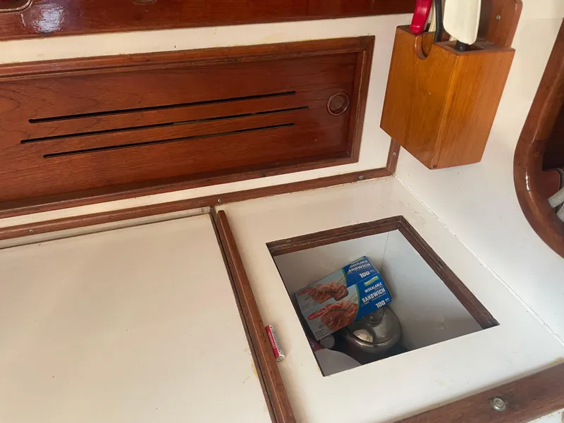 Slide: The Image of Interior of 1980 Cape Dory 36 sailboat with wooden cabinetry and storage compartment. - 35