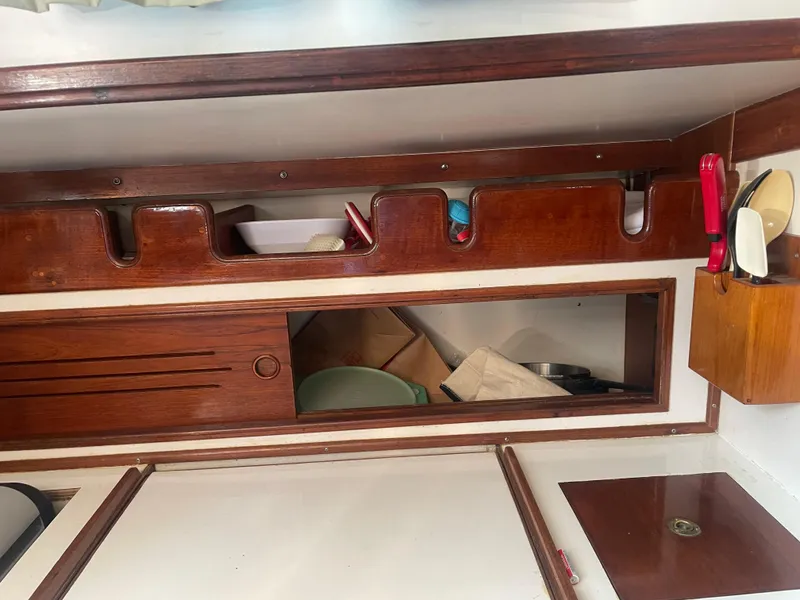 Slide: The Image of Interior of a 1980 Cape Dory 36 sailboat with wooden cabinetry and storage. - 36
