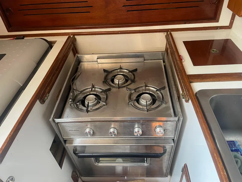 Slide: The Image of Cape Dory 36 (1980) yacht kitchen with stainless steel stove and oven. - 38