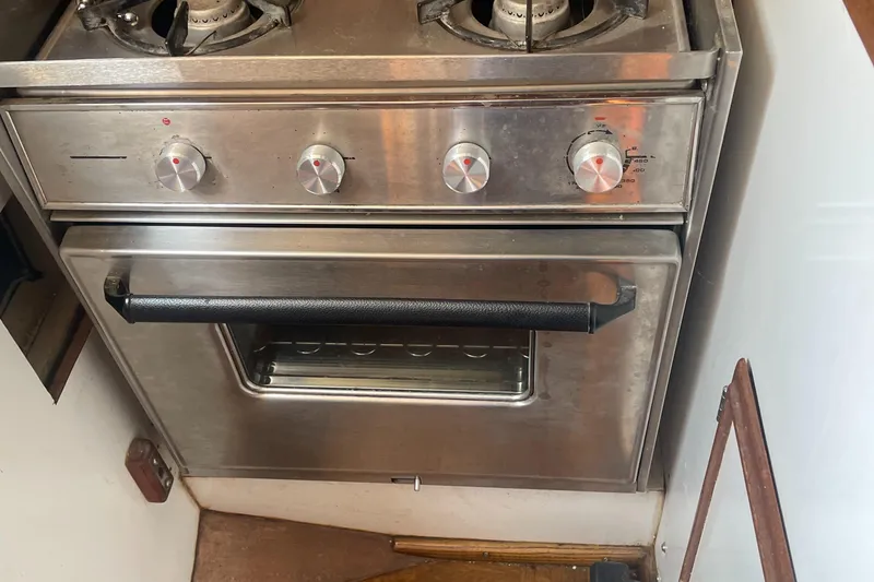 Slide: The Image of Stainless steel stove and oven in a 1980 Cape Dory 36 boat kitchen. - 41