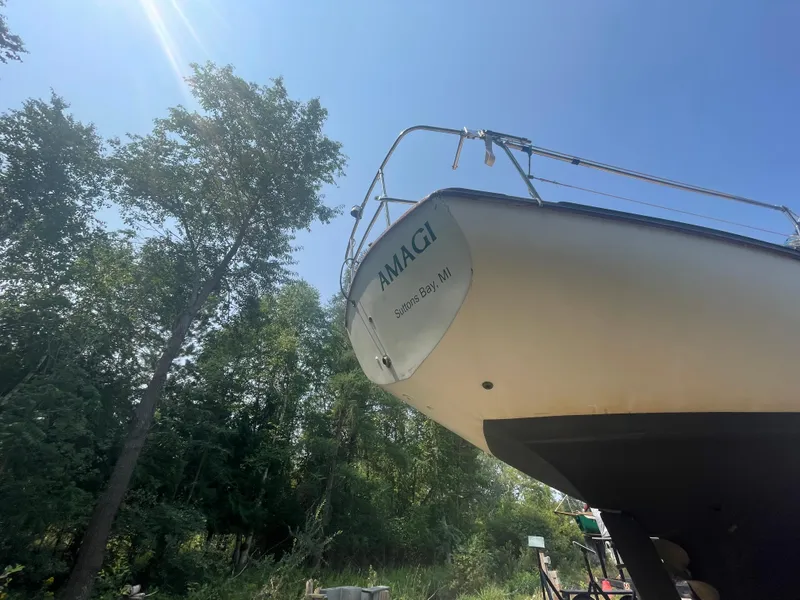 Slide: The Image of 1980 Cape Dory 36 sailboat on land, sunny day, trees in background. - 6