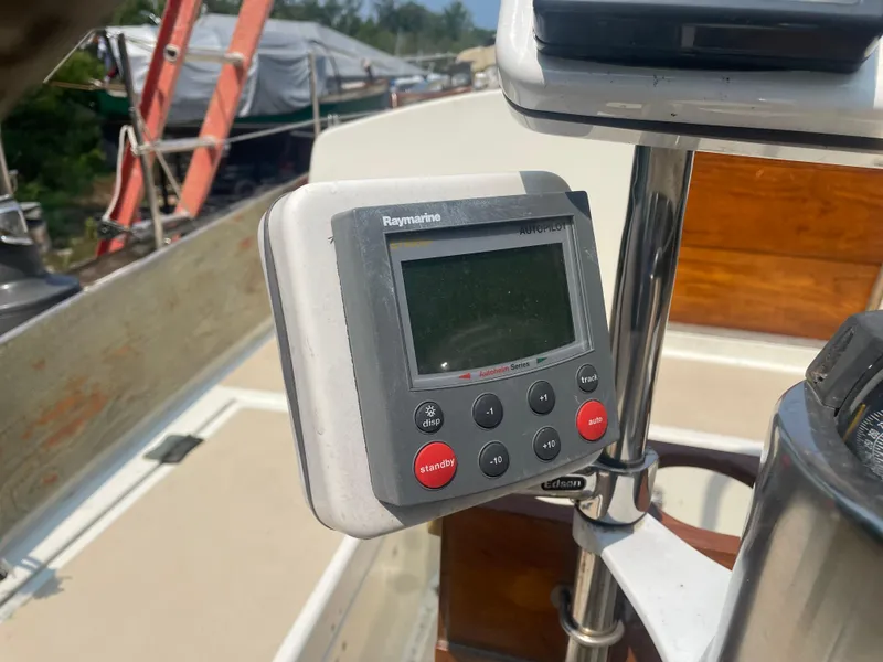 Slide: The Image of Raymarine autopilot control on 1980 Cape Dory 36 sailboat, docked with covered boats nearby. - 8