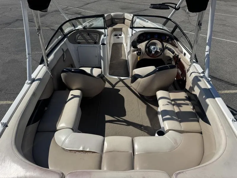 Slide: The Image of Interior of 2002 Tigé 2300V Limited boat with beige seating and steering console. - 10