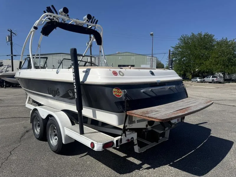 Slide: The Image of 2002 Tigé 2300V Limited boat on trailer, outdoor setting, clear sky. - 12