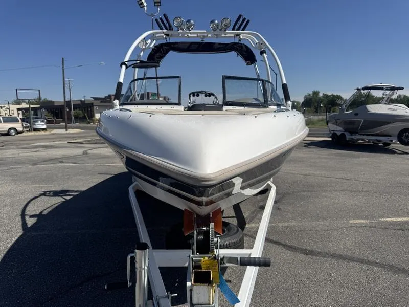 Slide: The Image of Engine compartment of a 2002 Tigé 2300V Limited boat, showing detailed components. - 2