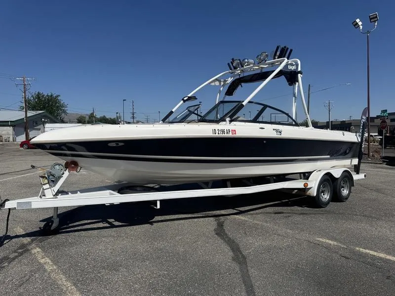 Slide: The Image of 2002 Tigé 2300V Limited boat on trailer, front view, parked outdoors. - 3