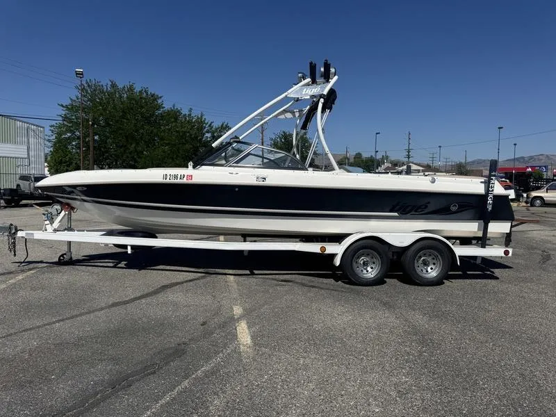 Slide: The Image of 2002 Tigé 2300V Limited boat on trailer in parking lot, sunny day. - 4