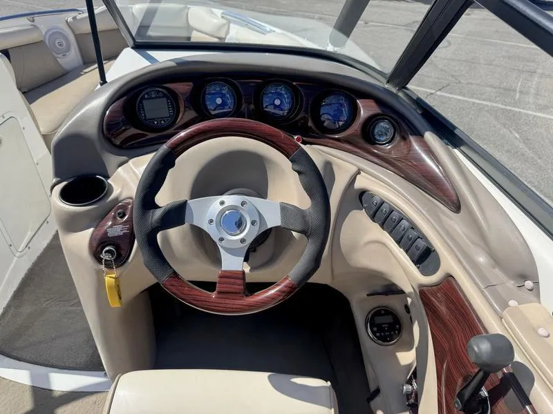 Slide: The Image of 2002 Tigé 2300V Limited boat dashboard with wood accents and steering wheel. - 5