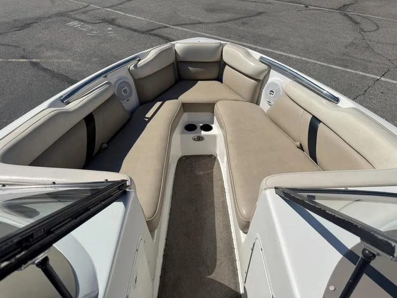 Slide: The Image of 2002 Tigé 2300V Limited boat interior with beige seating and cup holders. - 6