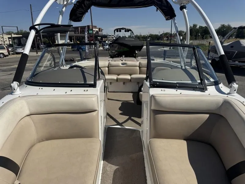 Slide: The Image of 2002 Tigé 2300V Limited boat interior with beige seating and open deck layout. - 7
