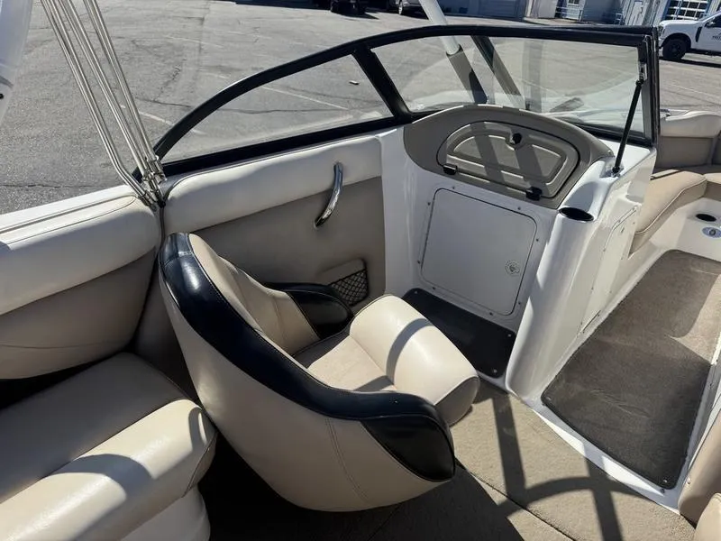Slide: The Image of 2002 Tigé 2300V Limited boat interior with beige and black seating. - 8