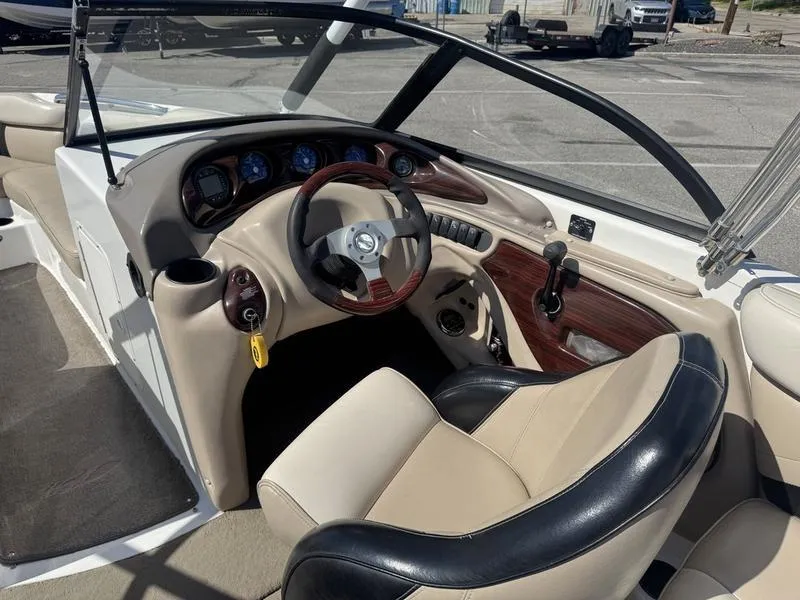 Slide: The Image of Interior of 2002 Tigé 2300V Limited boat with steering wheel and dashboard controls. - 9