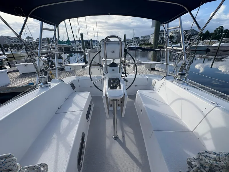 Slide: The Image of Cockpit of 2011 Catalina 355 sailboat docked at marina, featuring dual helm and seating. - 11