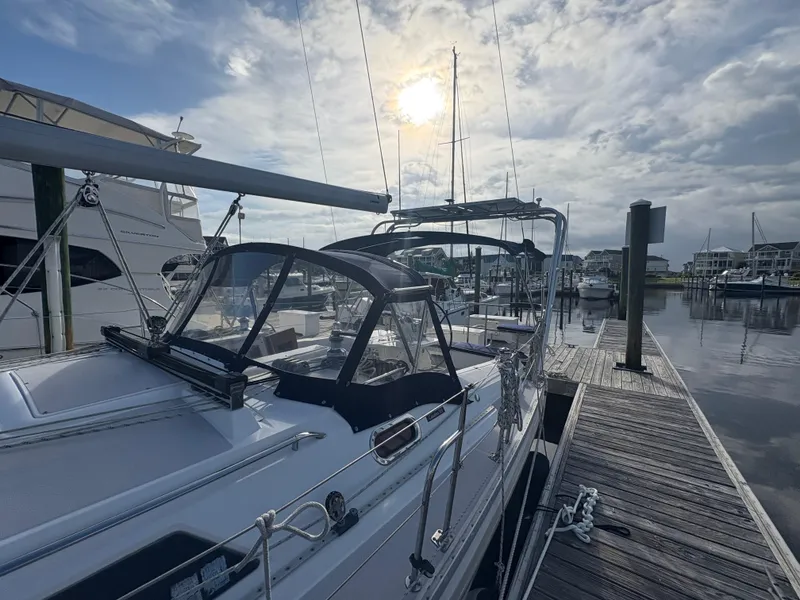 Slide: The Image of 2011 Catalina 355 sailboat docked at marina under cloudy sky. - 14