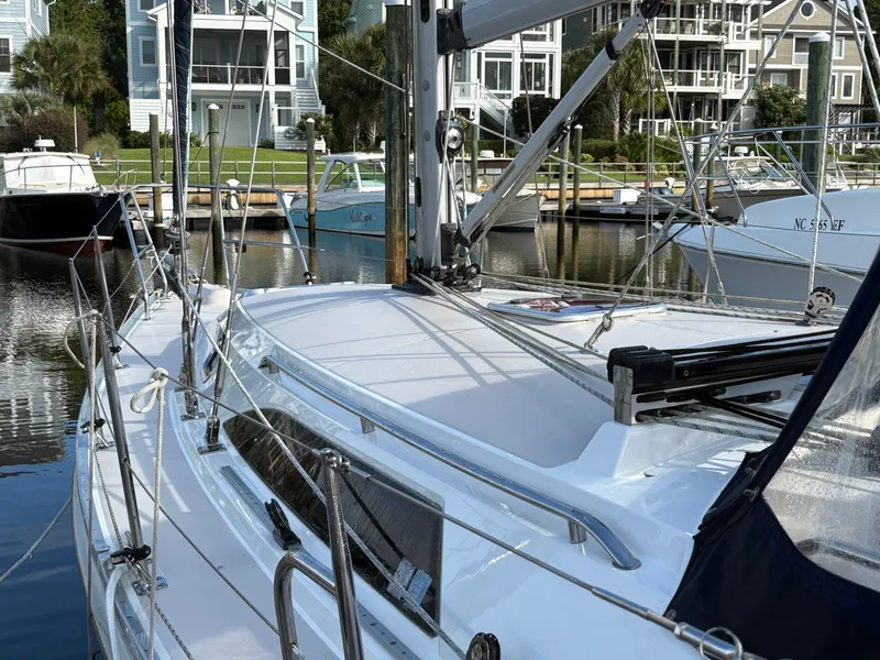 Slide: The Image of Sailboat Catalina 355, 2011 model, docked in a marina with waterfront homes in the background. - 15