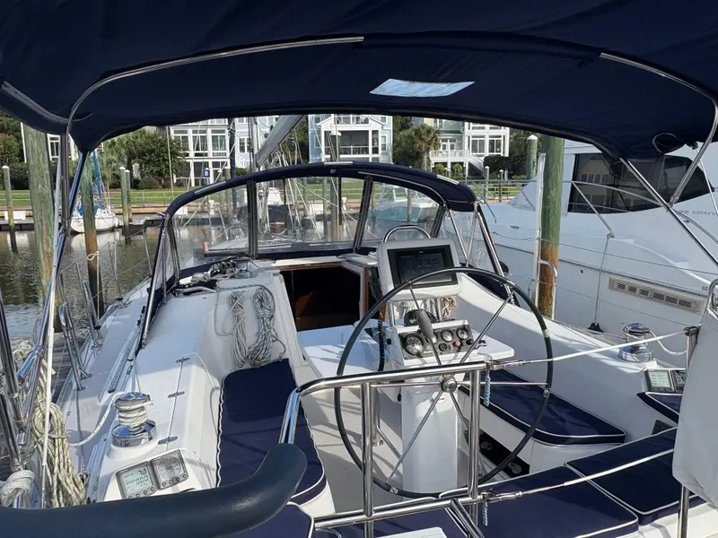 Slide: The Image of Cockpit view of a 2011 Catalina 355 sailboat docked at a marina. - 16