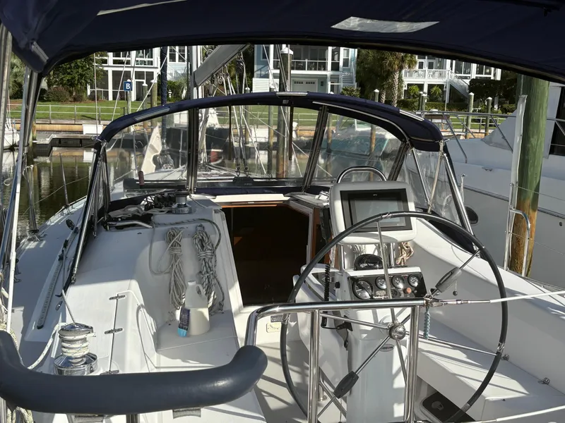 Slide: The Image of Cockpit of a 2011 Catalina 355 sailboat with steering wheel and navigation equipment. - 17