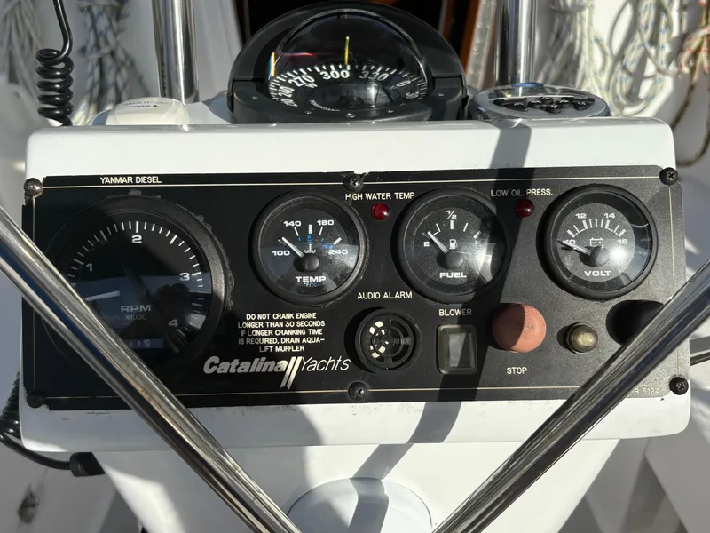 Slide: The Image of Control panel of a 2011 Catalina 355 yacht, featuring gauges and switches. - 19