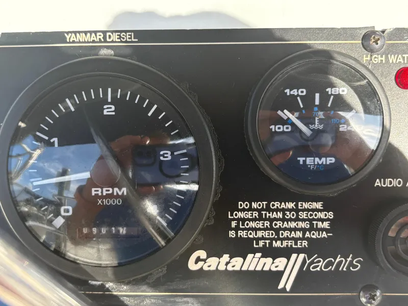 Slide: The Image of Close-up of Catalina 355 yacht dashboard with RPM and temperature gauges. - 20