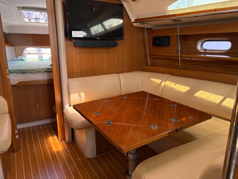Slide: The Image of Interior of 2011 Catalina 355 yacht with cozy seating and wooden table. - 28