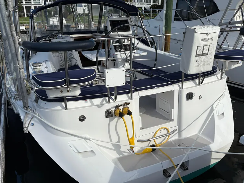 Slide: The Image of Sailboat Catalina 355, 2011 model, docked in a marina with waterfront homes. - 3