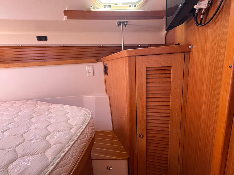 Slide: The Image of Interior of 2011 Catalina 355 sailboat with wooden cabinetry and mattress. - 31