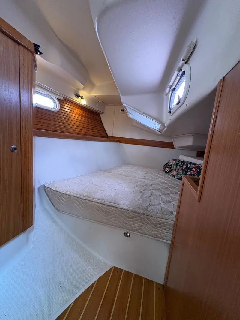 Slide: The Image of Cozy cabin interior of 2011 Catalina 355 sailboat with wooden accents and mattress. - 34