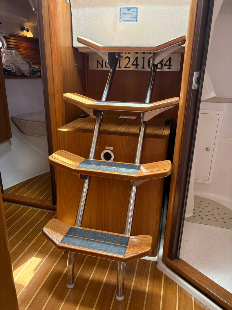 Slide: The Image of Interior of 2011 Catalina 355 sailboat with wooden steps and cabin entry. - 36