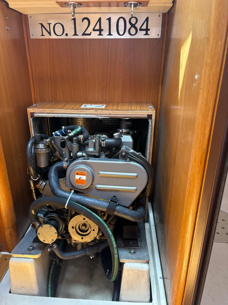 Slide: The Image of Engine compartment of a 2011 Catalina 355 sailboat, showing engine and serial number 1241084. - 37