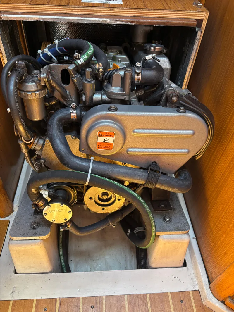 Slide: The Image of Engine compartment of a 2011 Catalina 355 sailboat, showcasing detailed mechanical components. - 38