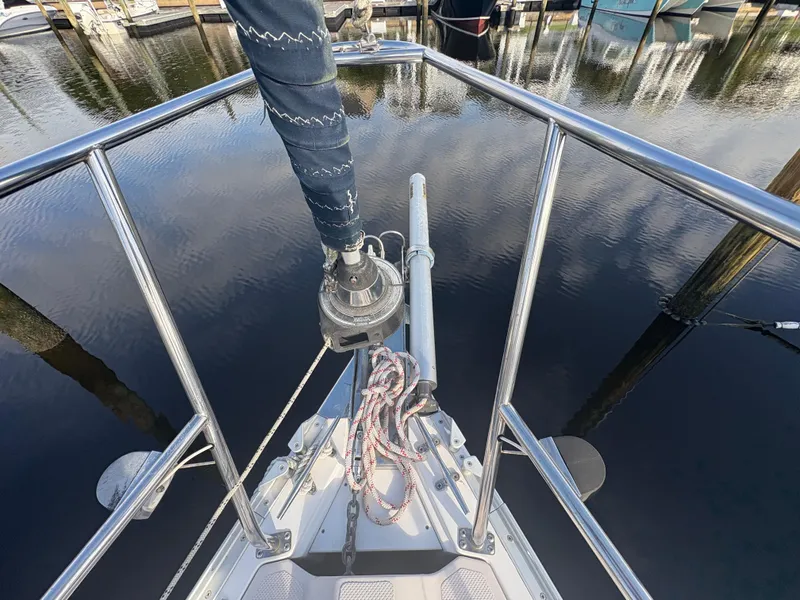 Slide: The Image of 2011 Catalina 355 sailboat docked at a marina, partially obscured by a pole. - 39