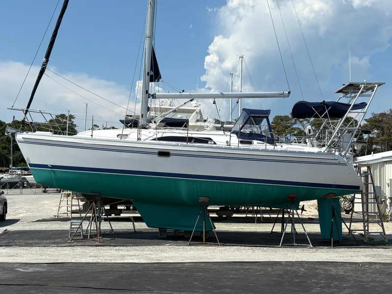 Slide: The Image of Sailboat Catalina 355, 2011 model, on stands in a boatyard under a partly cloudy sky. - 48