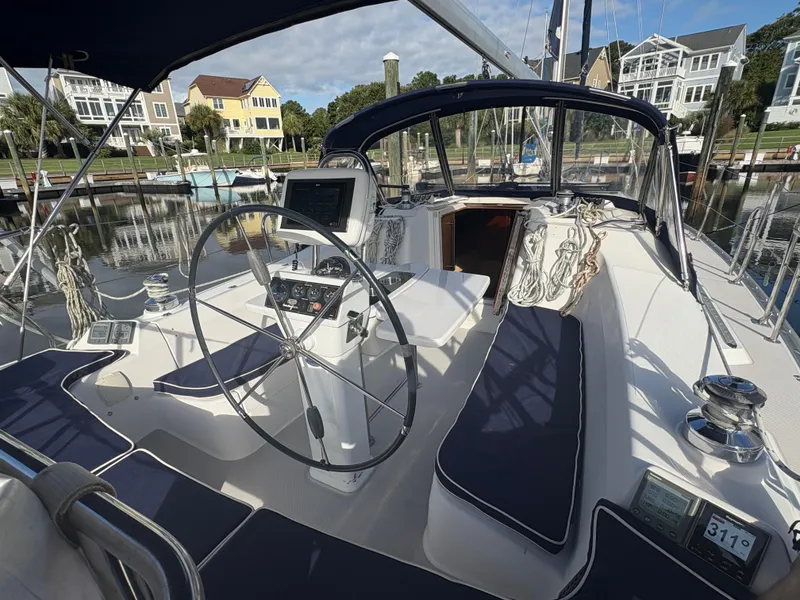 Slide: The Image of Cockpit of a 2011 Catalina 355 sailboat with steering wheel and navigation equipment. - 5