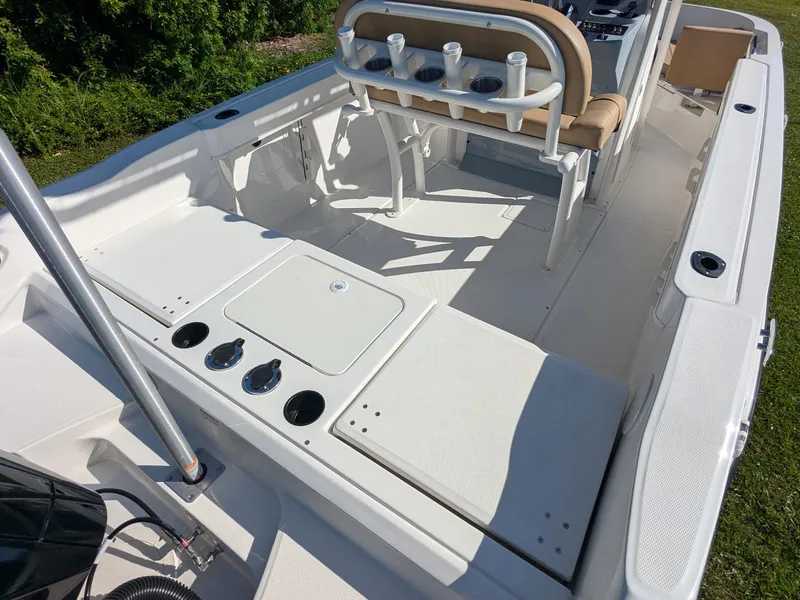 Slide: The Image of 2025 Bayliner Trophy T20CC boat interior with seating and rod holders. - 15