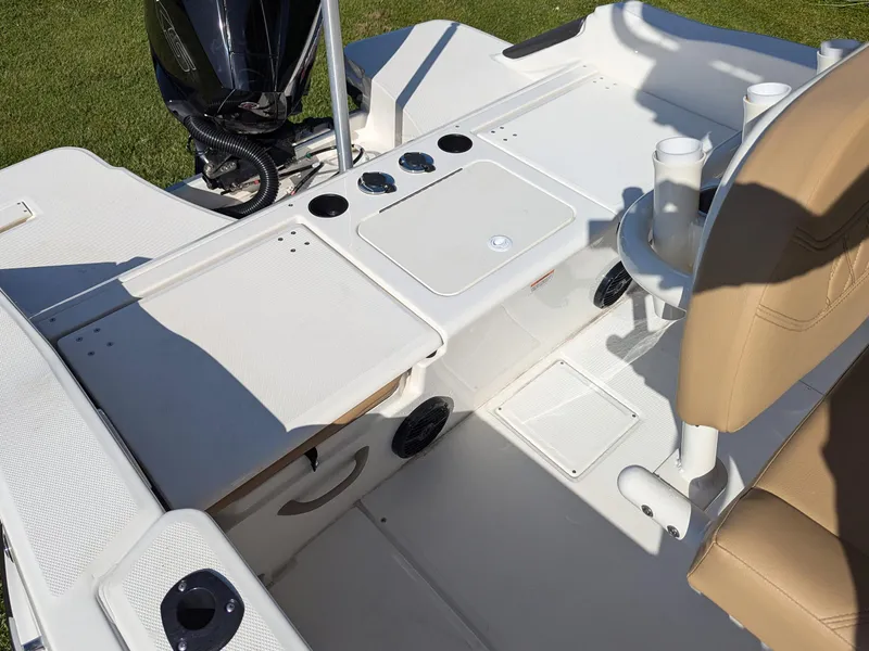 Slide: The Image of 2025 Bayliner Trophy T20CC boat interior with seating and motor, showcasing modern design. - 16