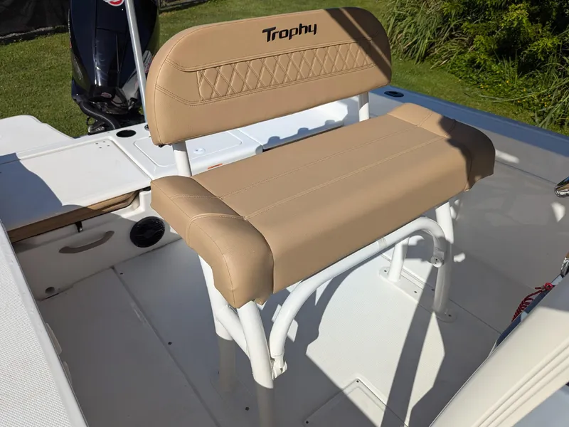 Slide: The Image of 2025 Bayliner Trophy T20CC boat seat with tan upholstery and white frame. - 17