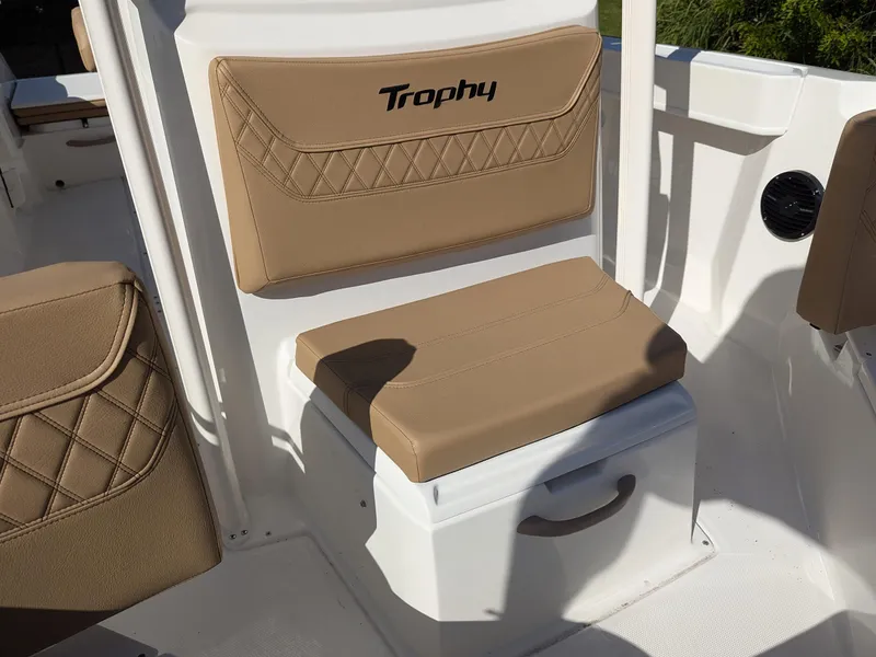 Slide: The Image of 2025 Bayliner Trophy T20CC boat seat with tan upholstery and storage compartment. - 19