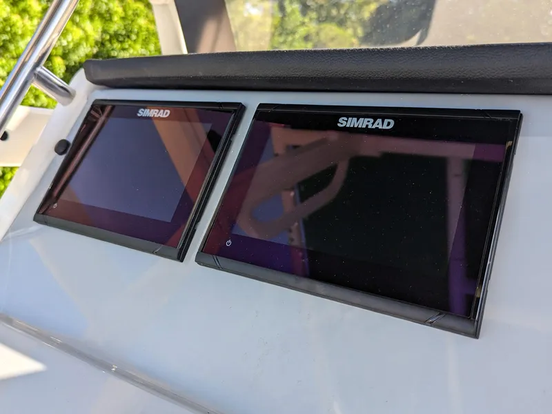 Slide: The Image of 2025 Bayliner Trophy T20CC dashboard with dual Simrad displays. - 22