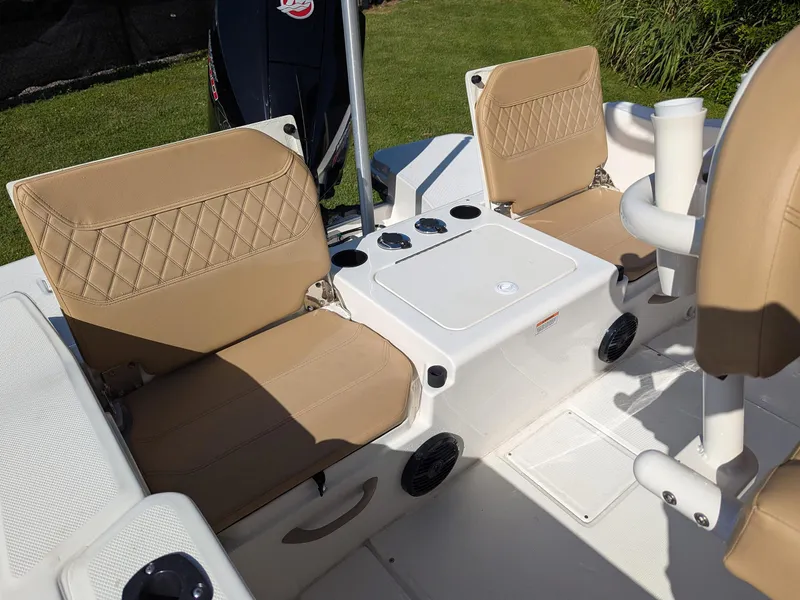 Slide: The Image of 2025 Bayliner Trophy T20CC boat interior with tan seating and storage compartments. - 23