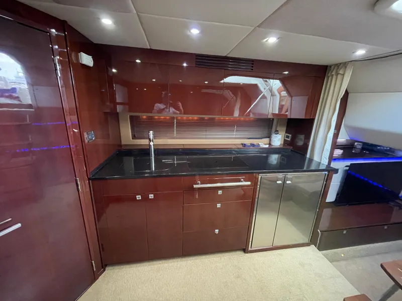 Slide: The Image of Luxurious interior of 2010 Sea Ray 450 Sundancer yacht with modern kitchen amenities. - 13