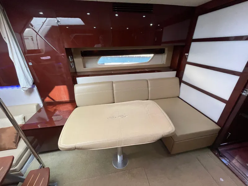 Slide: The Image of Interior of 2010 Sea Ray 450 Sundancer boat, featuring a round speaker and window view. - 14