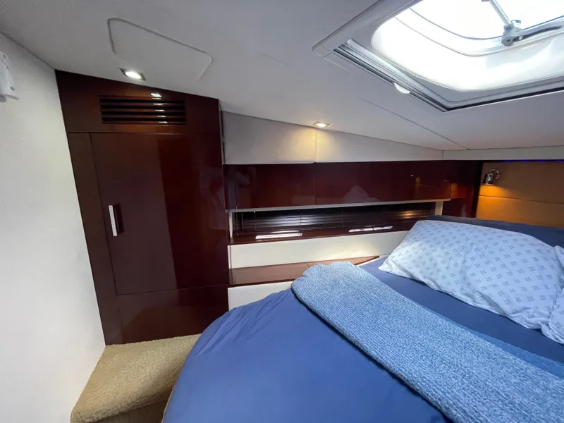 Slide: The Image of Luxurious cabin interior of 2010 Sea Ray 450 Sundancer with skylight and cozy bedding. - 18