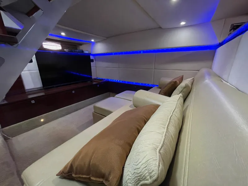 Slide: The Image of Luxurious interior of 2010 Sea Ray 450 Sundancer with modern seating and ambient lighting. - 27