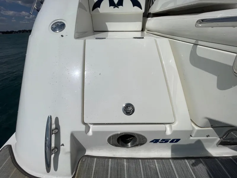 Slide: The Image of 2010 Sea Ray 450 Sundancer boat deck with storage compartment and cleat. - 30