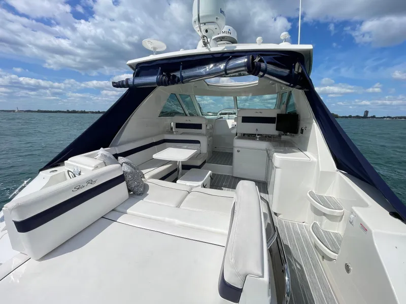 Slide: The Image of 2010 Sea Ray 450 Sundancer yacht interior with seating, table, and ocean view. - 34