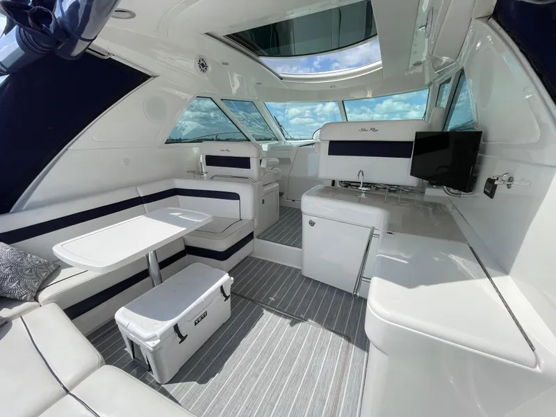 Slide: The Image of Luxurious interior of 2010 Sea Ray 450 Sundancer yacht with seating, table, and TV. - 36